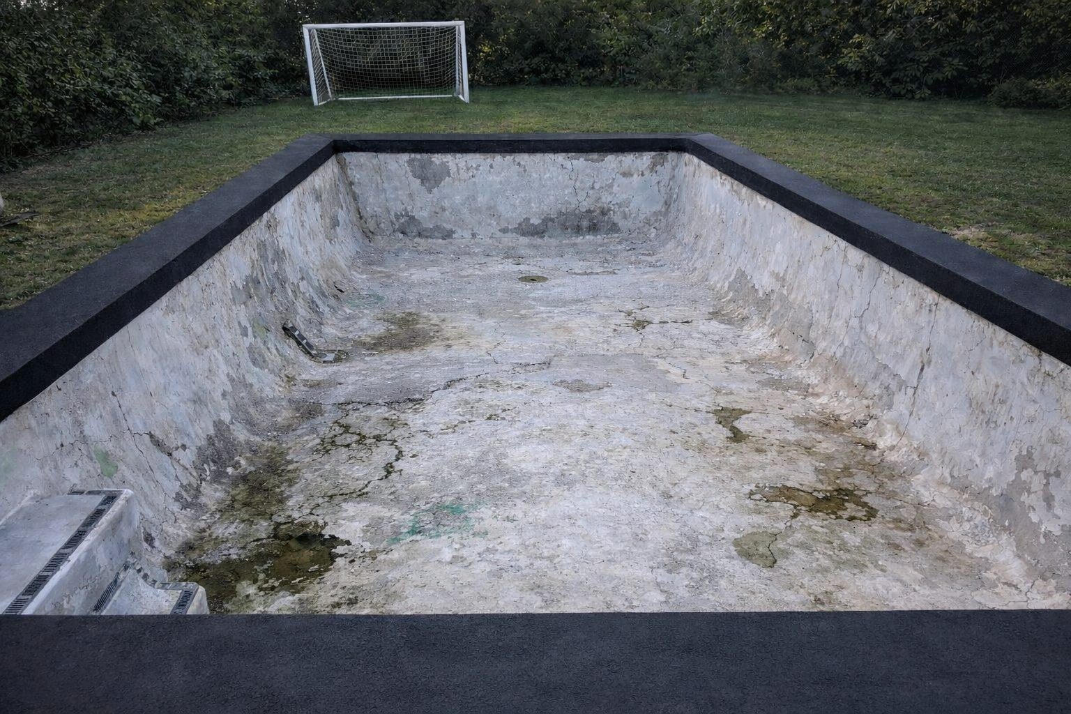 Pool before resurfacing — concrete pool, worn marblesheen